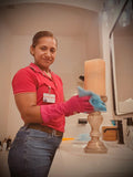 Person cleaning a lamp in a bathroom