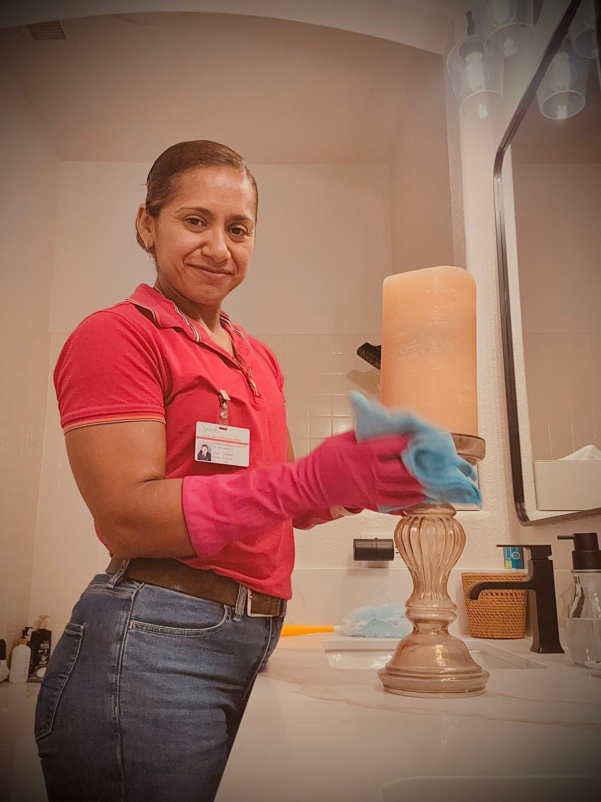 Person cleaning a lamp in a bathroom
